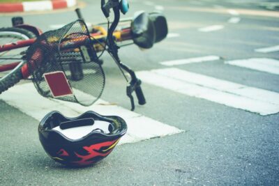 Helmet and bicycle lying in crosswalk