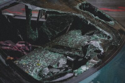 A car with a smashed windshield after a crash. A lawyer can explain what happens if you get into a car accident without insurance.