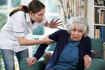 Care worker mistreating senior woman