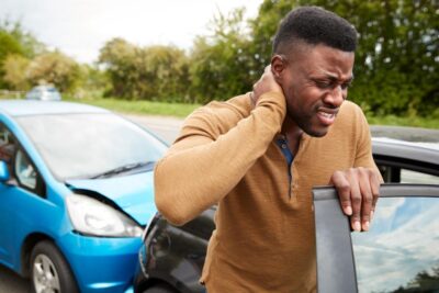 Man holds neck after car accident