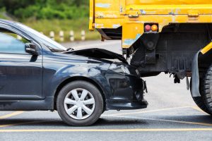 Front of car crushed under truck rear