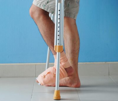 Man with ankle injury using crutches