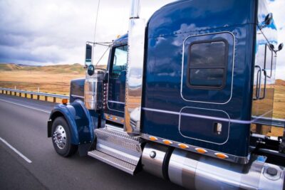 Side view of semi truck on highway