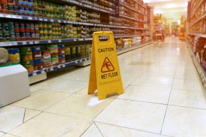 Wet floor sign in supermarket aisle