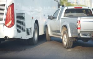 A pickup truck crashes into a bus