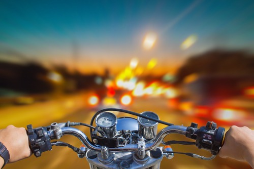 A motorcycle speeds into traffic.