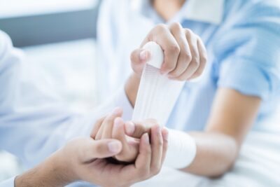 Doctor bandaging patients arm