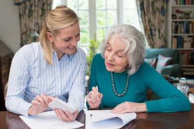 Elderly woman gets help with paperwork