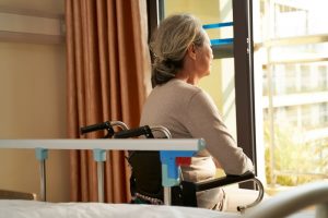 Asian woman sitting in a wheelchair