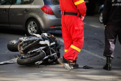 Crashed motorcycle with people around