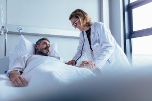 Doctor tending to a man in the hospital