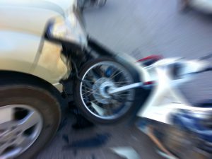 Impact of car and motorcycle crash