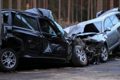 Two totaled cars after a head on collision