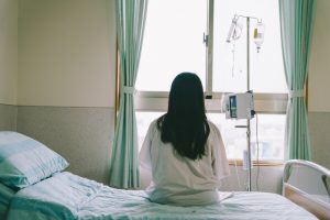 Woman sitting on a hospital bed