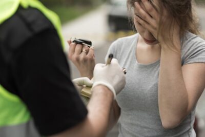 Woman taking a breathalyzer