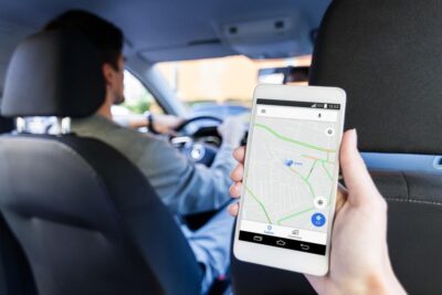 Passenger looks at map on phone to track rideshare