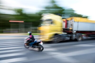 Speeding truck about to hit motorcyclist