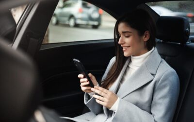 Woman rides in back seat of car