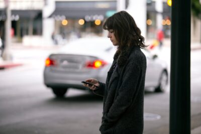 Woman views app and waits for car to arrive