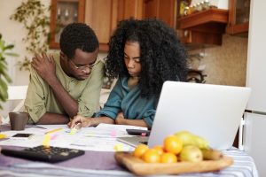 Young couple struggles with insurance paperwork