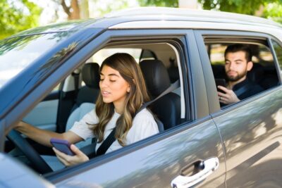 Female rideshare driver checking app