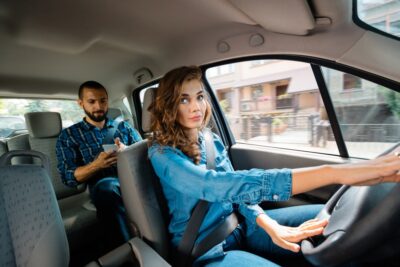 Female uber driver talking to male passenger