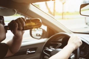 Guy drinking while driving