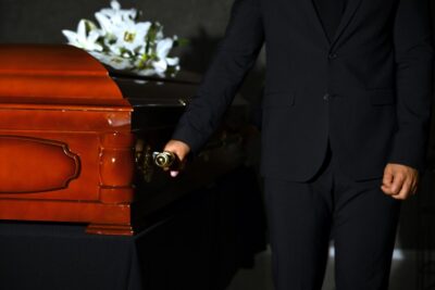 Men carrying wooden casket