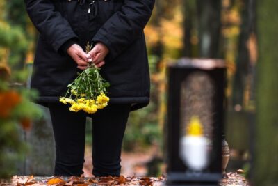 Mourning woman holding flowers