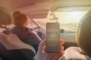 Passenger in back seat using rideshare app