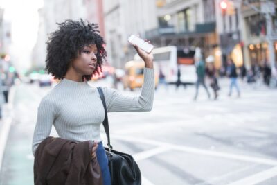 Woman hailing a rideshare