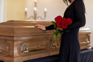 Woman mourning at a coffin