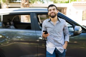 Young man at a lyft car