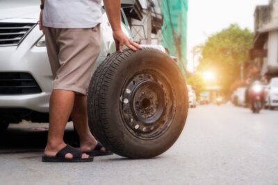 Guy rolling out a tire