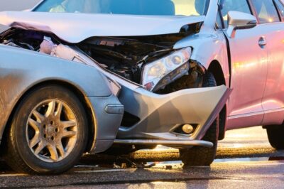 Head on crash showing crushed front end of vehicle