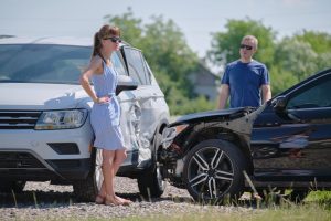 Man and woman dealing with a car accident