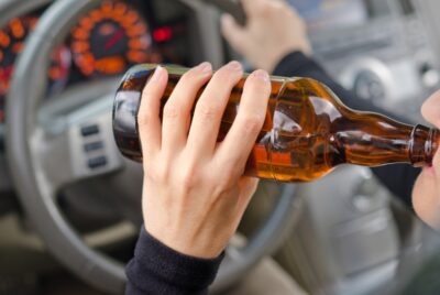 Man drinking alcohol behind the wheel