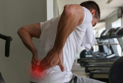 Man with back pain at the gym