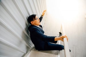 Asian man falling on stairs