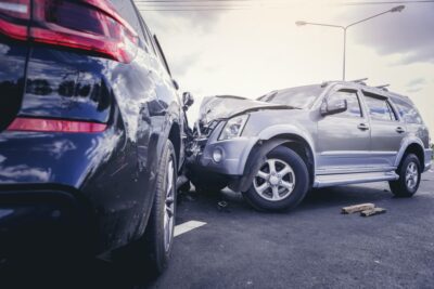 Blue car and silver suv in a crash