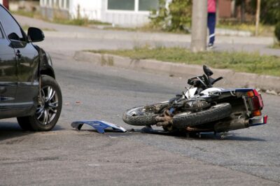 Car and motorcycle in road