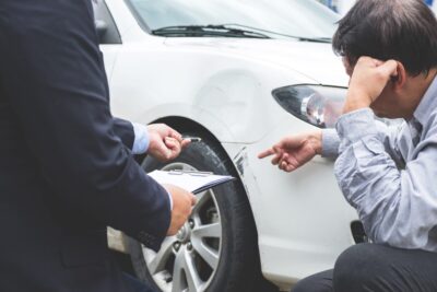 Insurance agent documenting accident