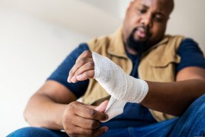 Man putting gauze on his hand