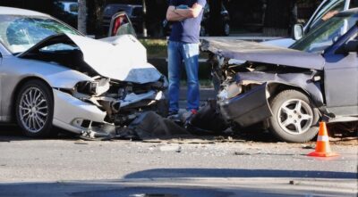 Man surveying a bad car accident