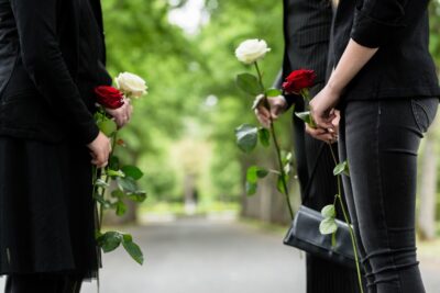 Mourners commiserating with flowers