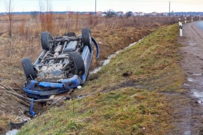 Overturned blue car