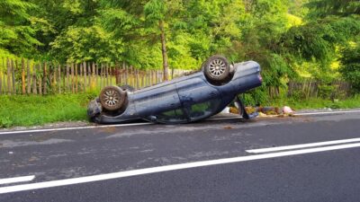 Overturned blue car on the road