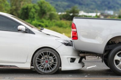 White car rear ending truck