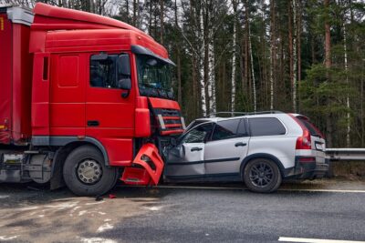 Collision between red truck and gray car