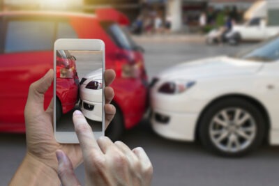 Woman taking picture of accident scaled